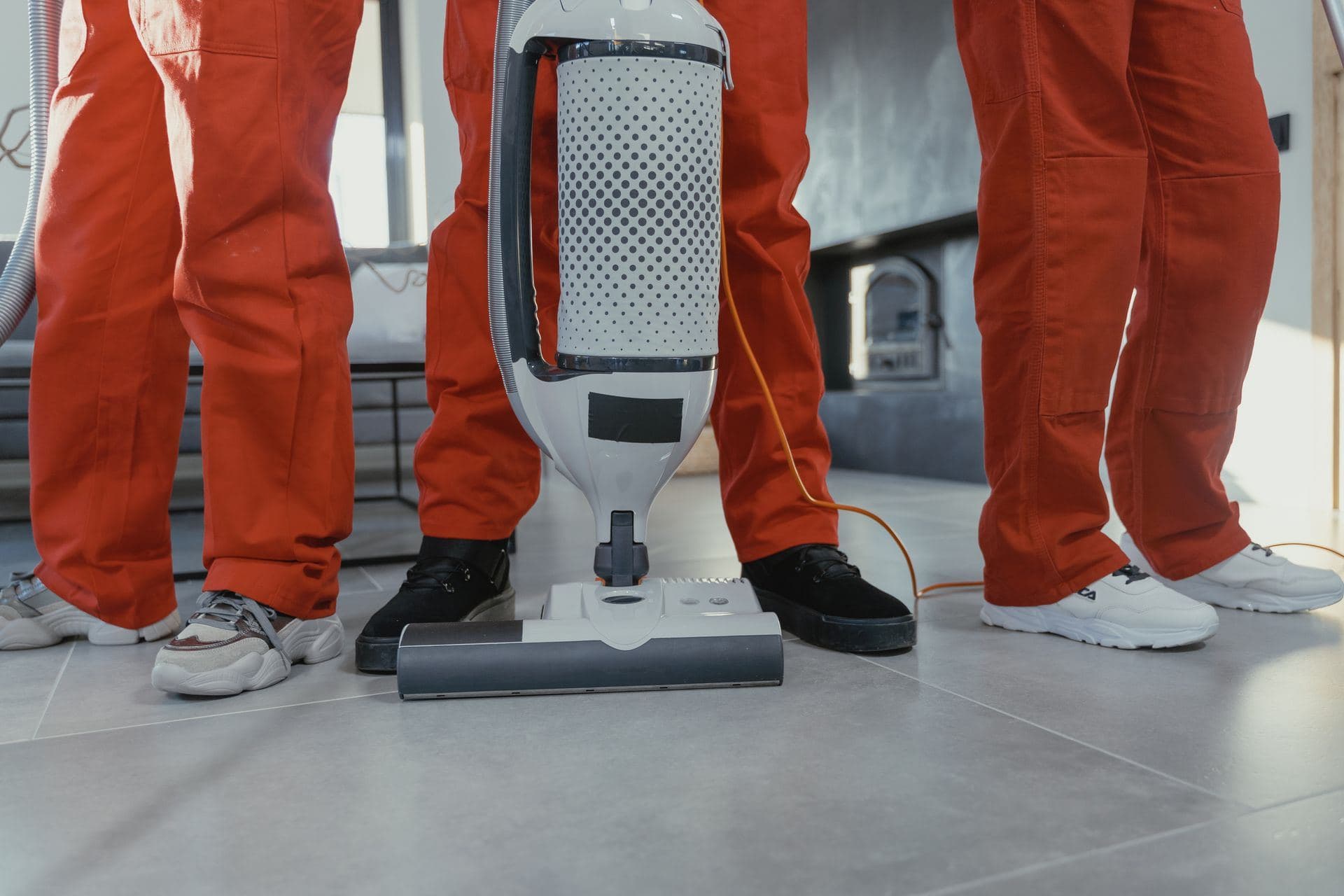Cleaning crew standing with an upright vacuum machine