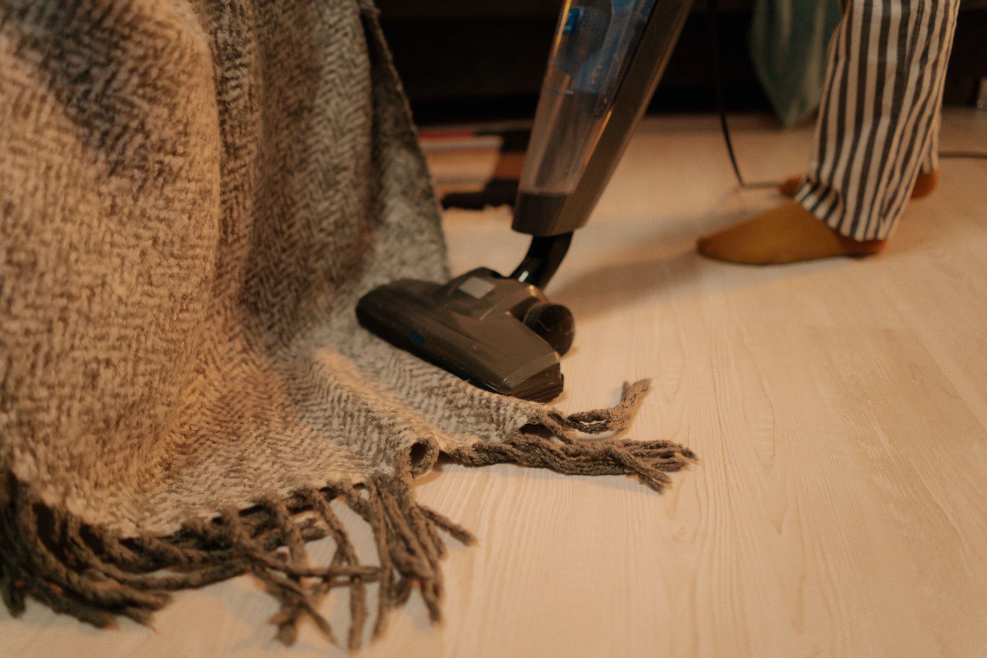 Vacuum nozzle cleaning a woven rug